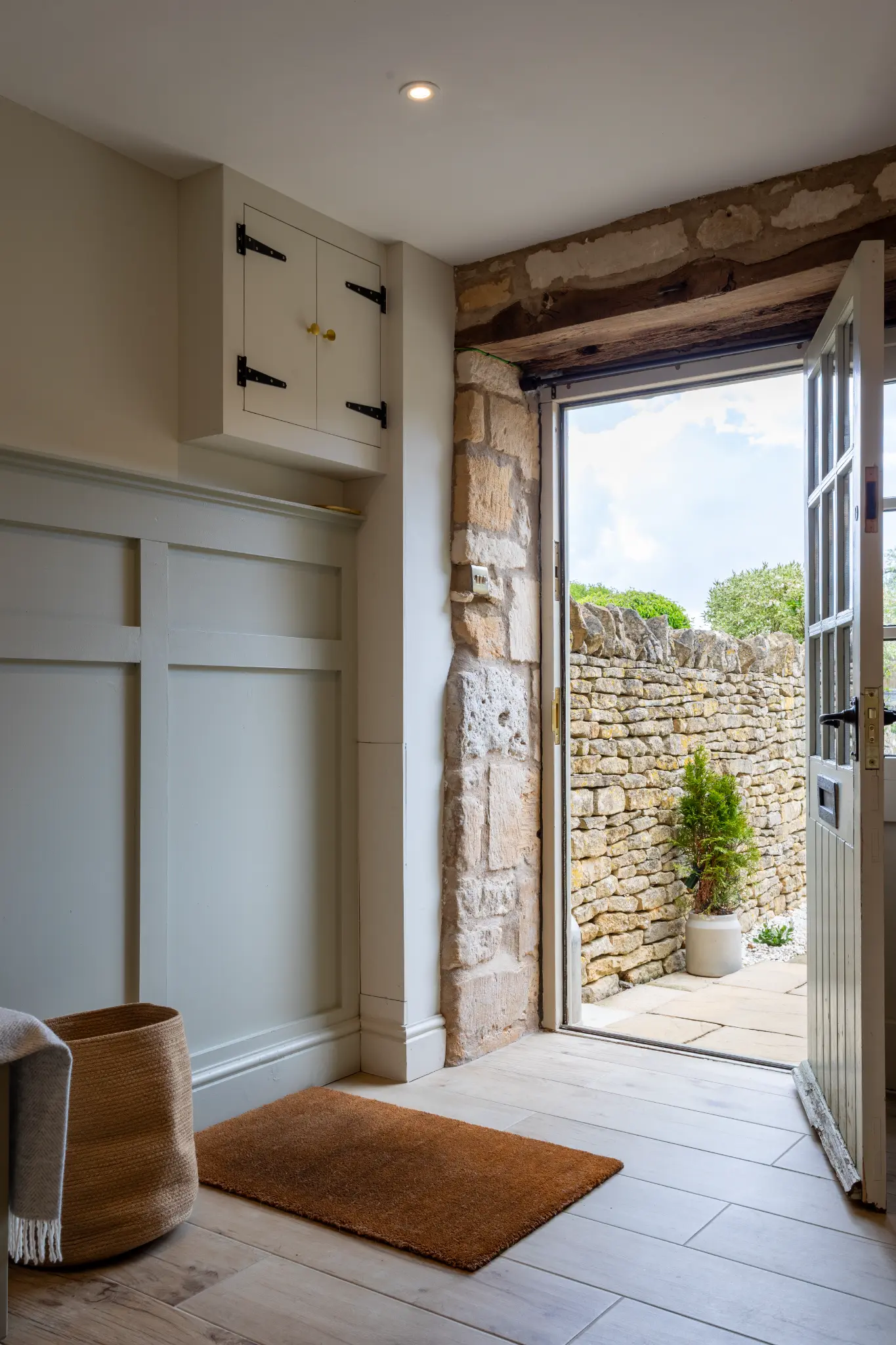 Hallway entrance with panelled walls and warm lighting