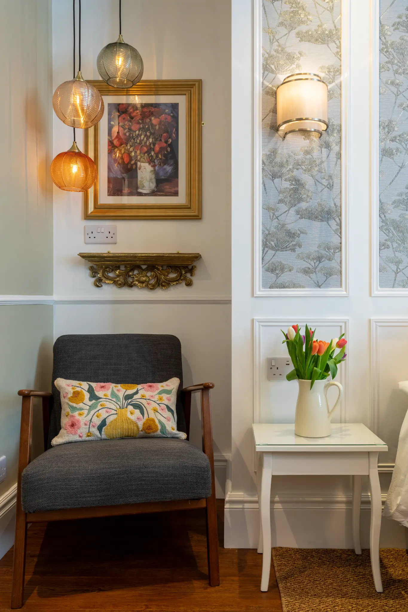 Mid-century chair with floral cushion and pendant lights at Ferndale Mews