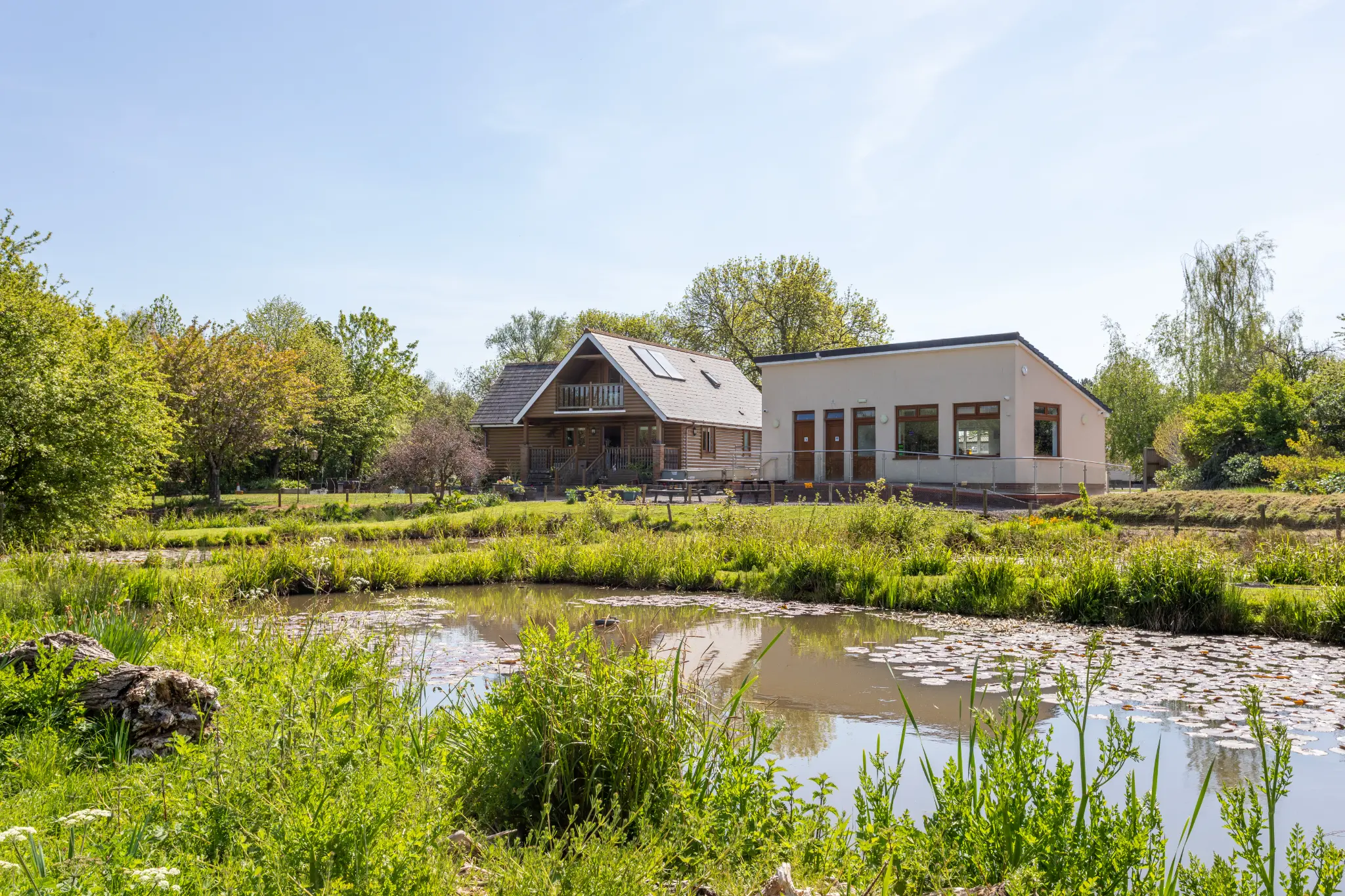 The Sedges lodge and clubhouse viewed from across the ornamental pond