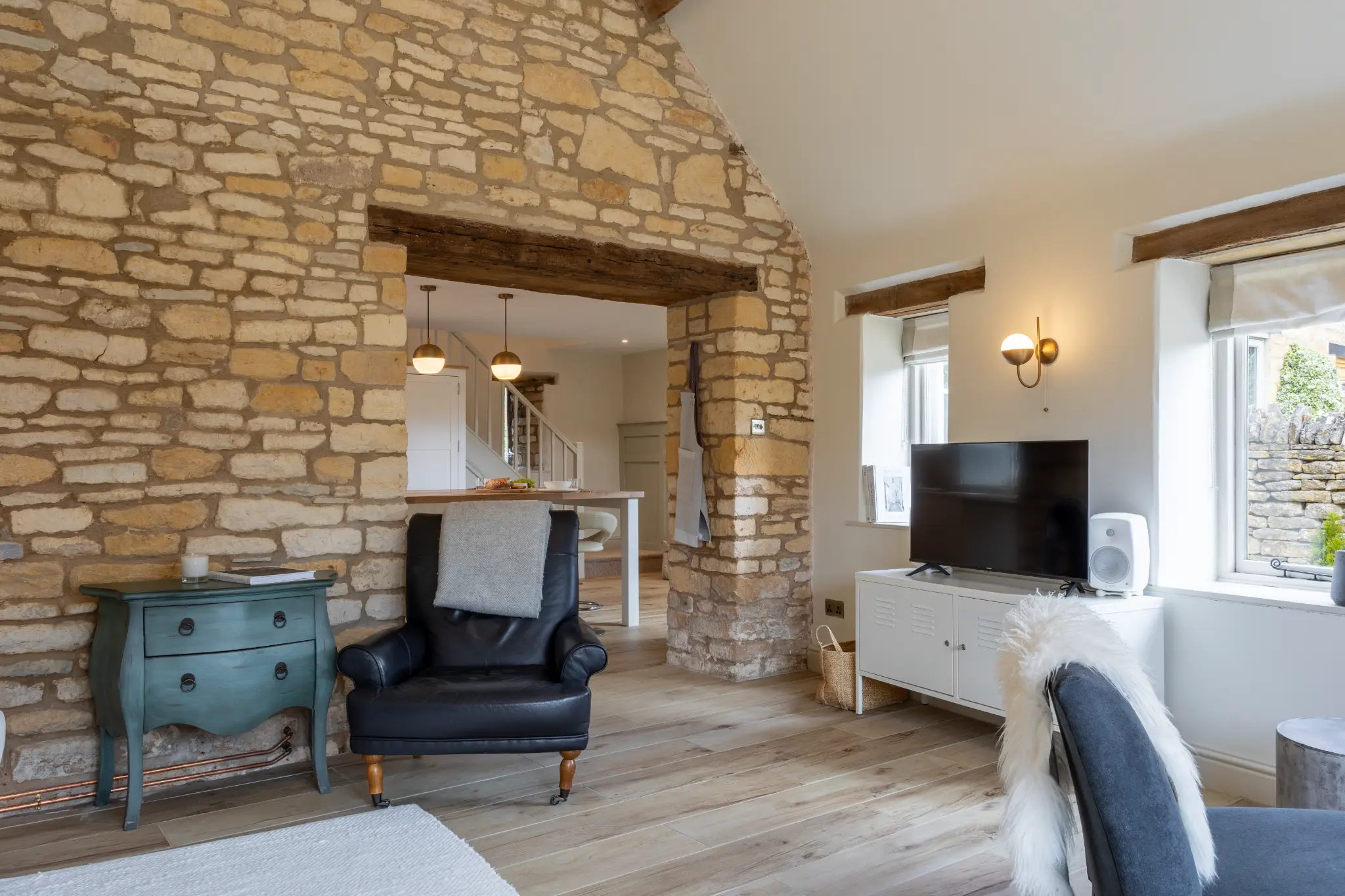 Living room with original stone arch and exposed beams