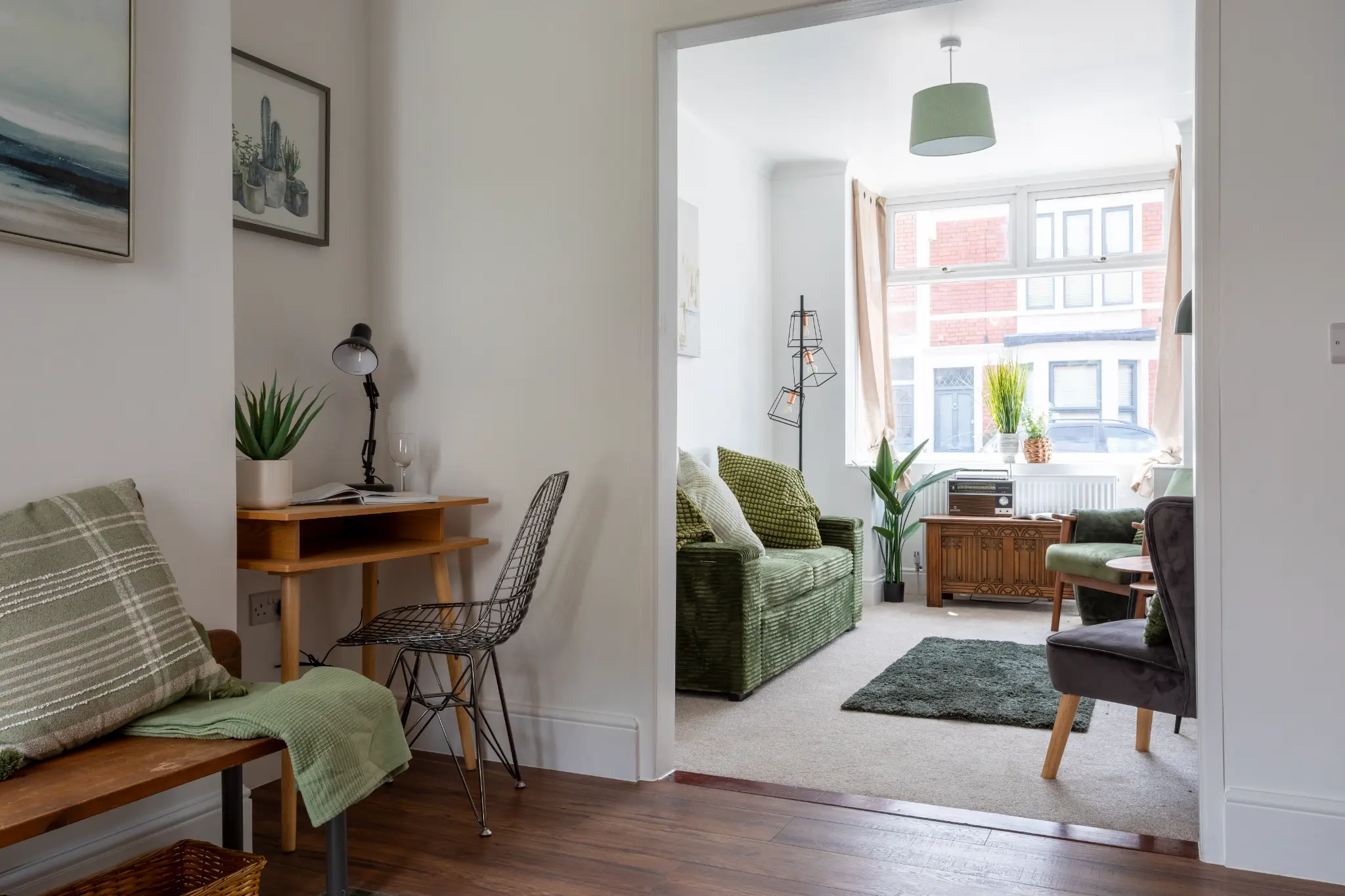 Hallway with wooden bench, desk nook and view through to living room in Bristol renovation
