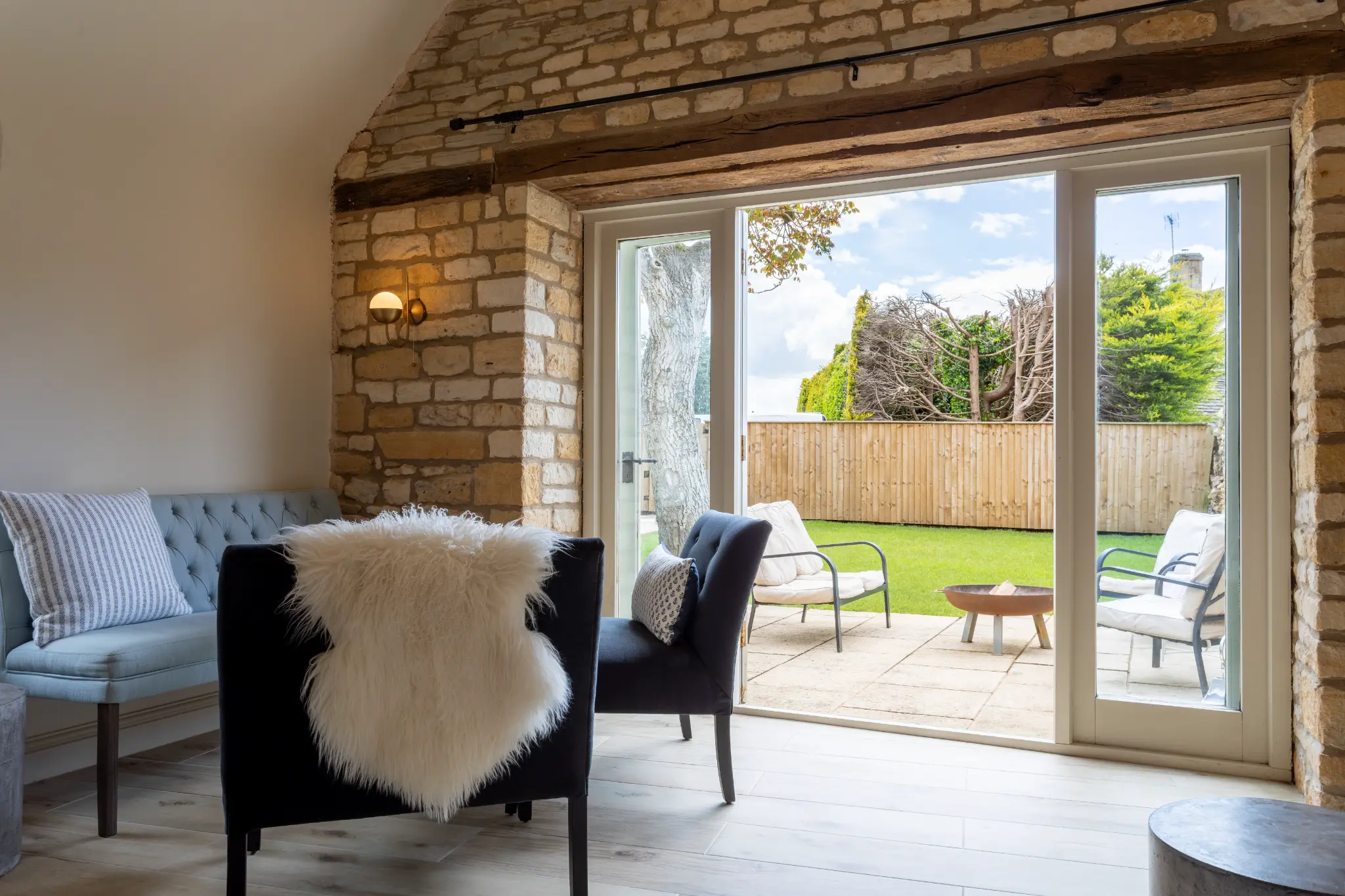 Living room with bifold doors open to the garden