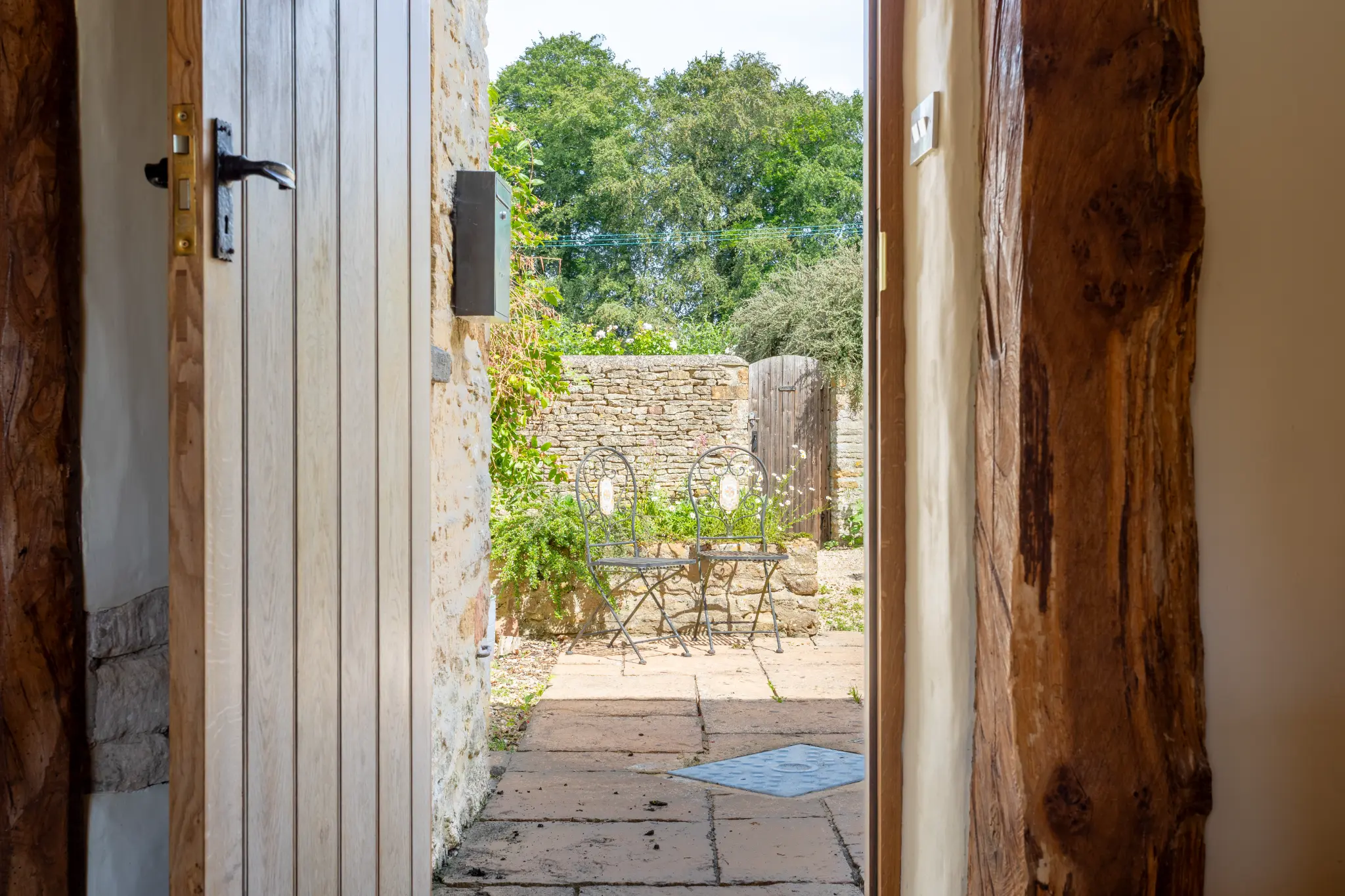 View through a cottage door to a stone courtyard