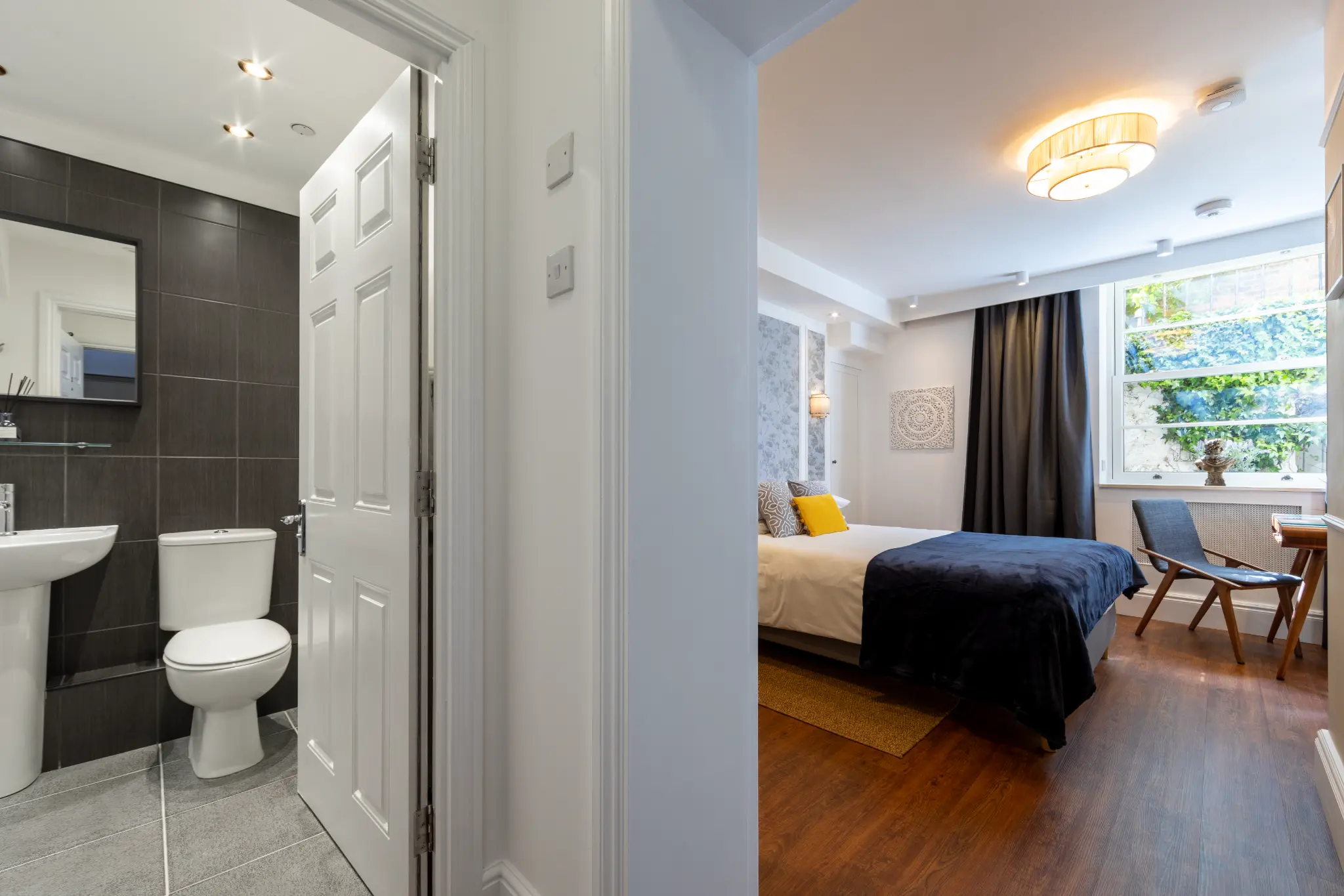 Professional photography showing bedroom and en-suite bathroom at Ferndale Mews