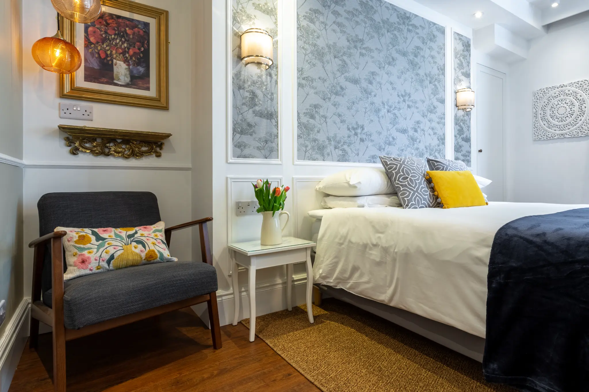 Close-up bedroom detail with accent cushions at Ferndale Mews