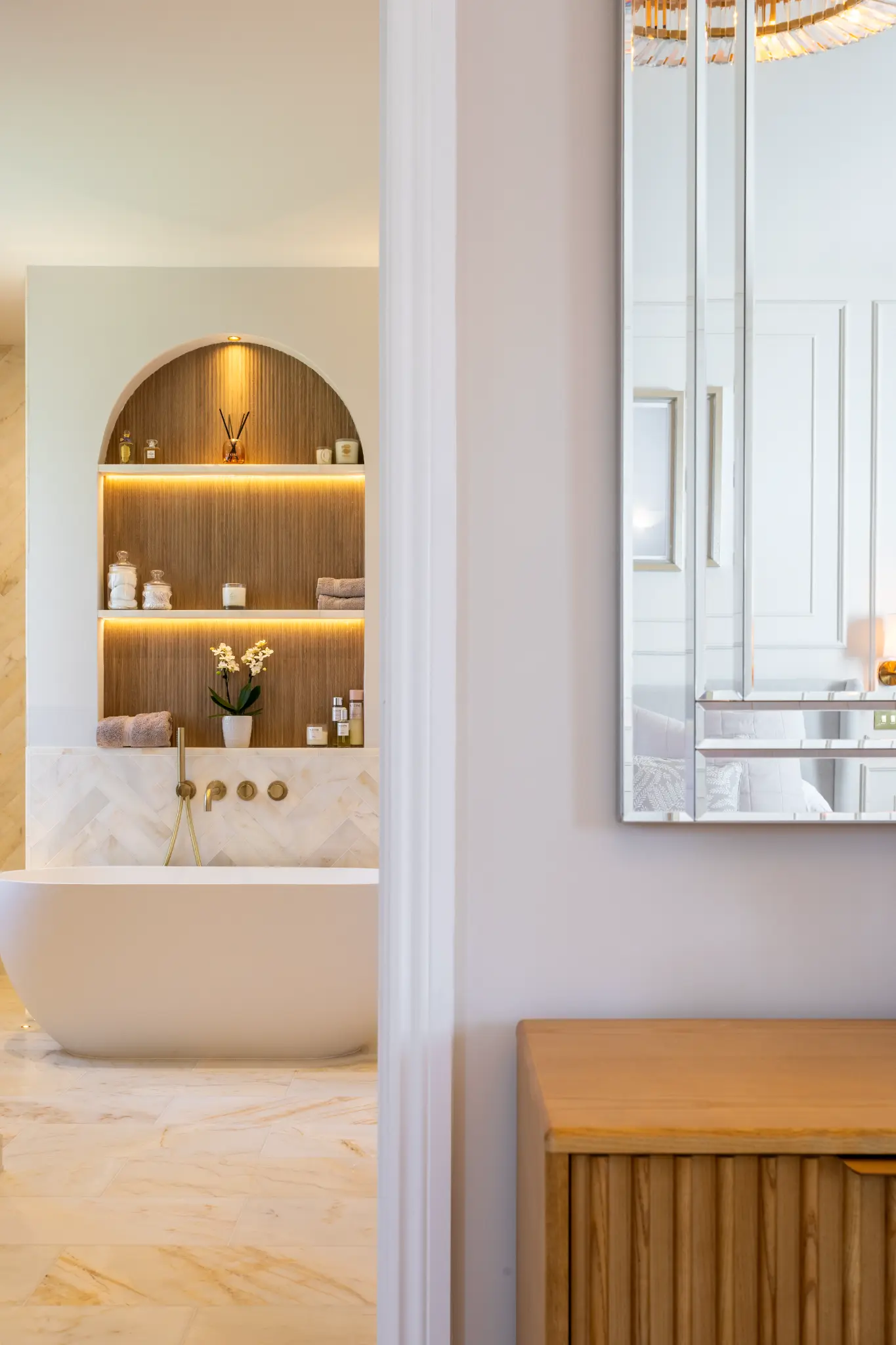 Marble bathroom with a freestanding bath and brass fittings