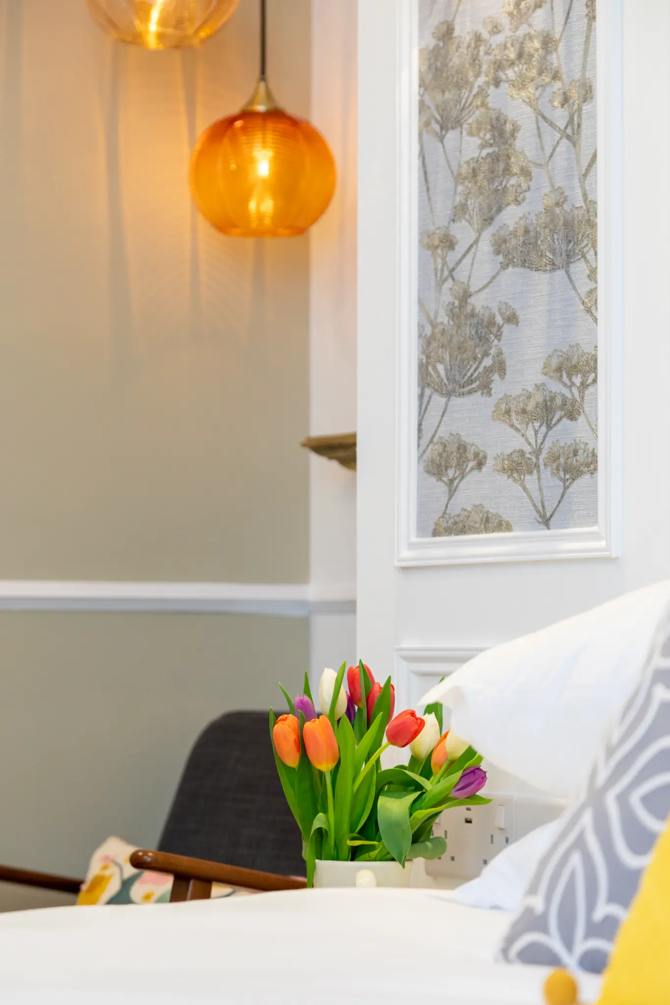Fresh tulips and amber pendant light detail at Ferndale Mews