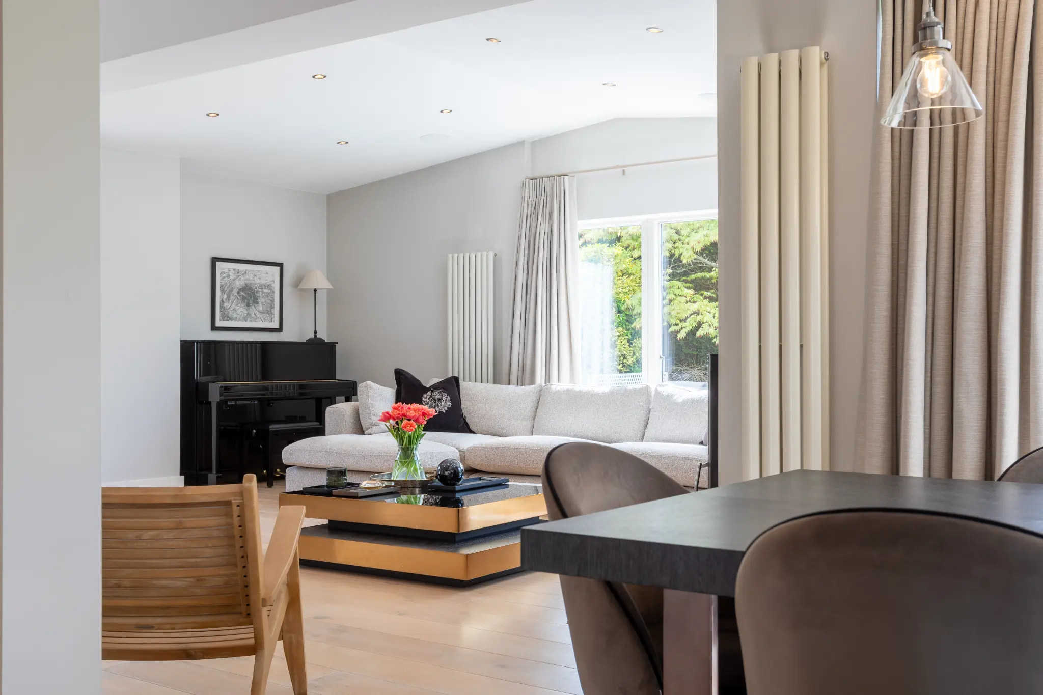 Open plan reception room with a piano and designer furniture