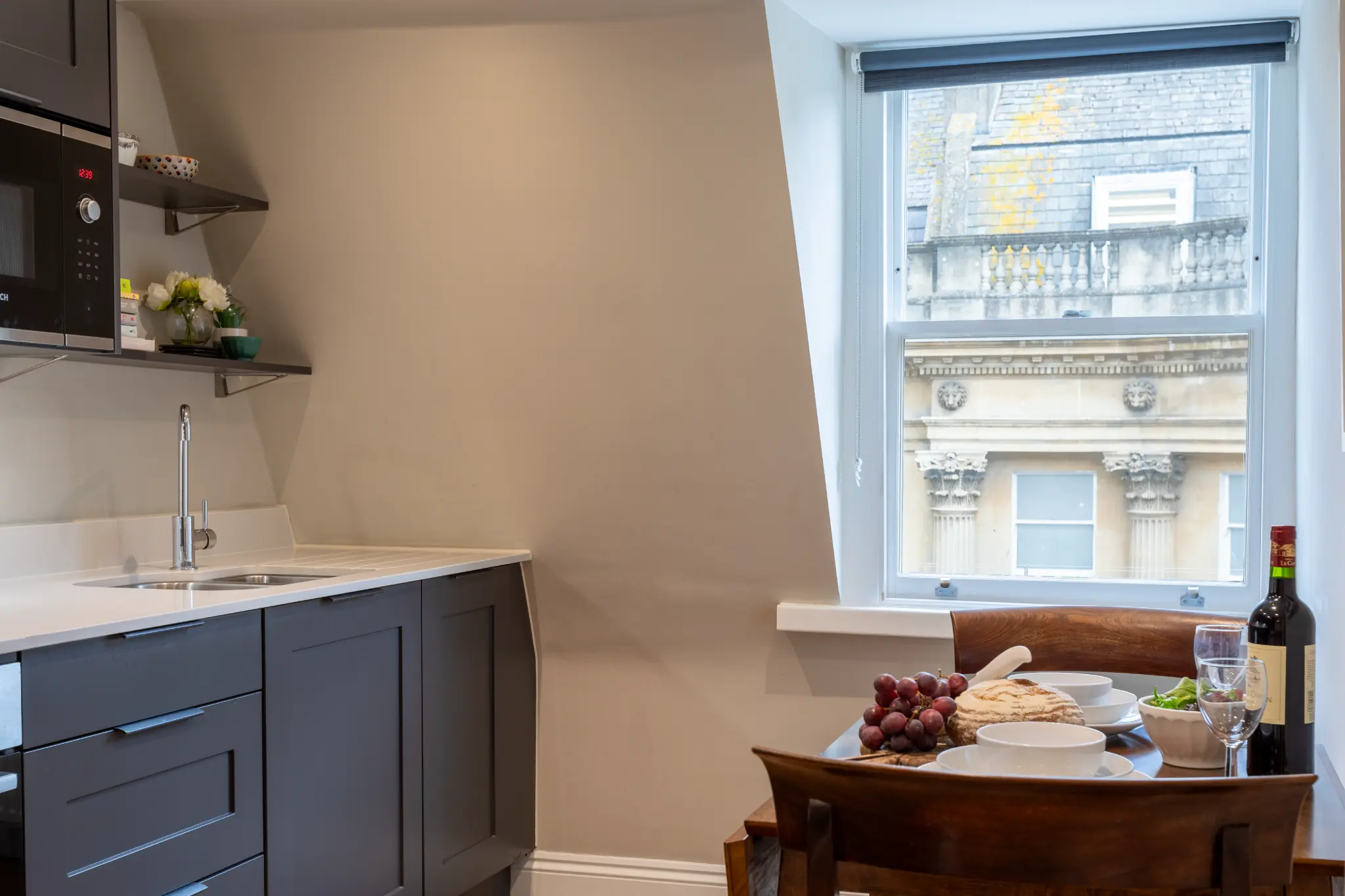 Modern kitchenette with dining area and views of Bath architecture