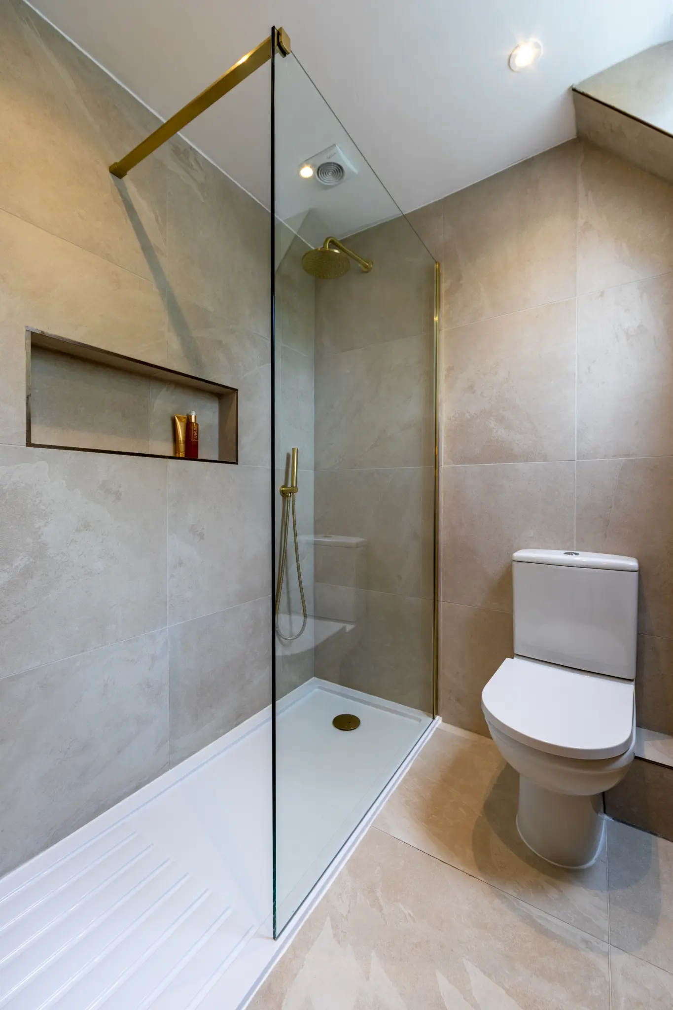Luxury bathroom with brass fittings and warm lighting