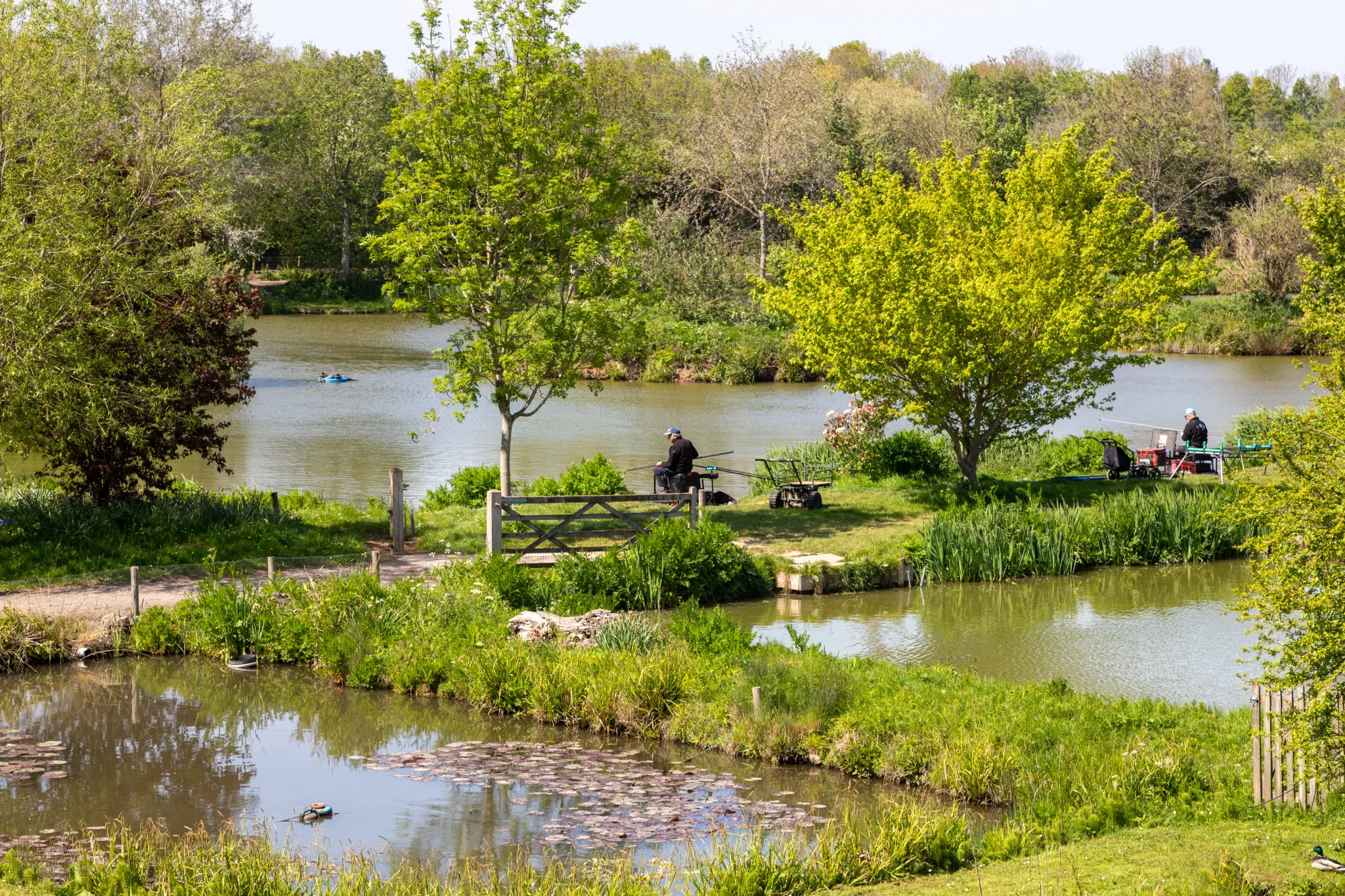 Anglers fishing at The Sedges with multiple lakes visible in the background