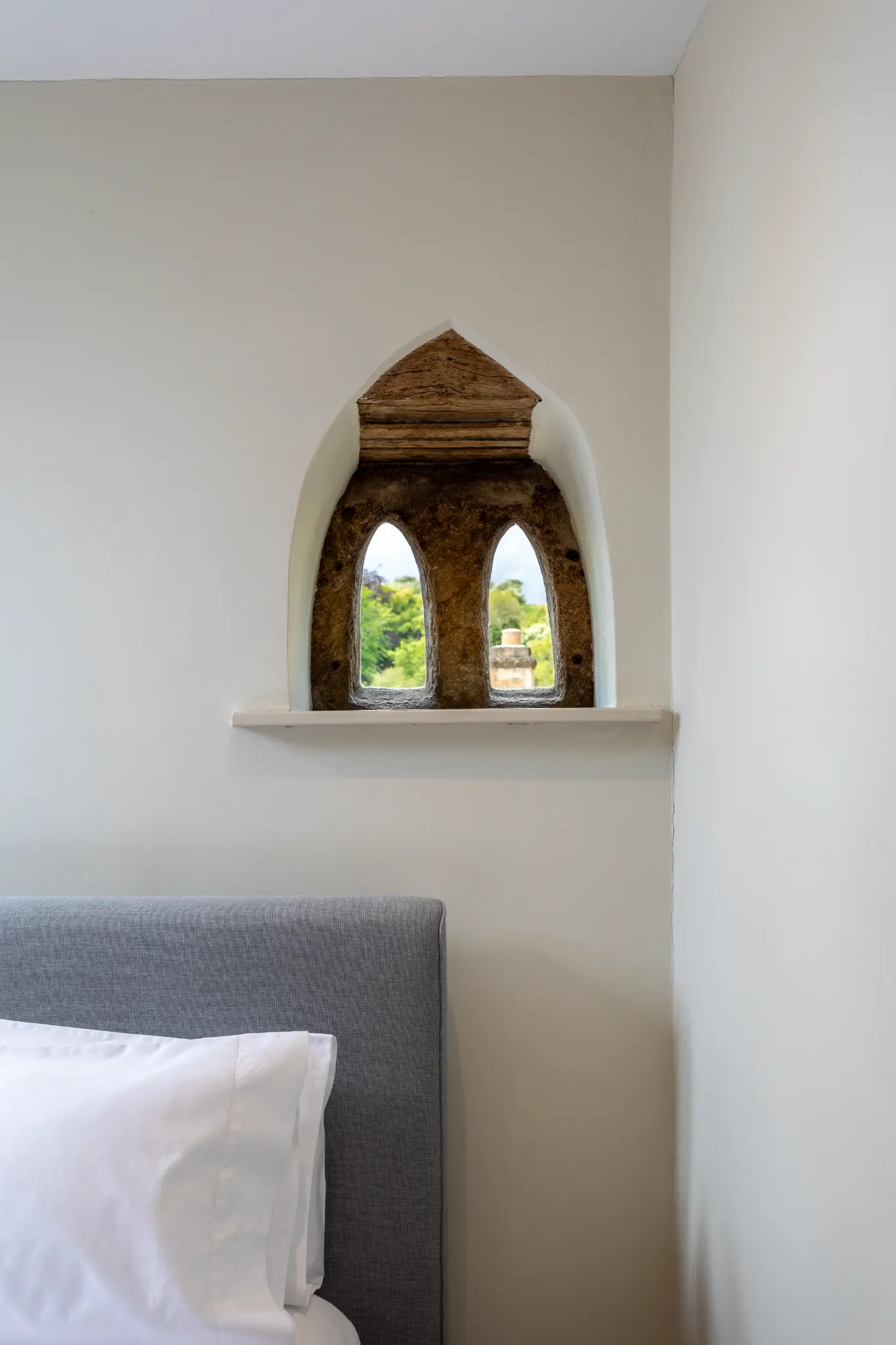 Original arched window with deep stone reveal