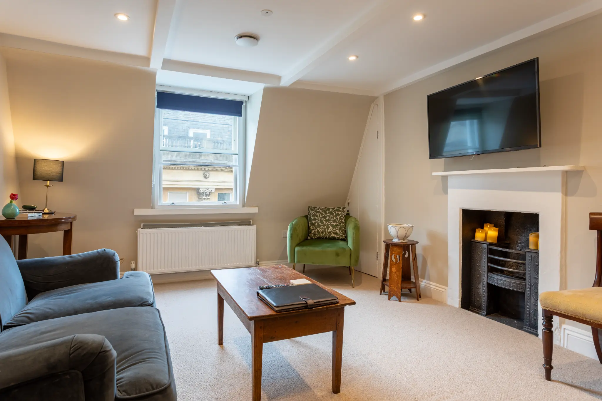 Alternative angle of Milsom Apartments living room showing window views over Bath