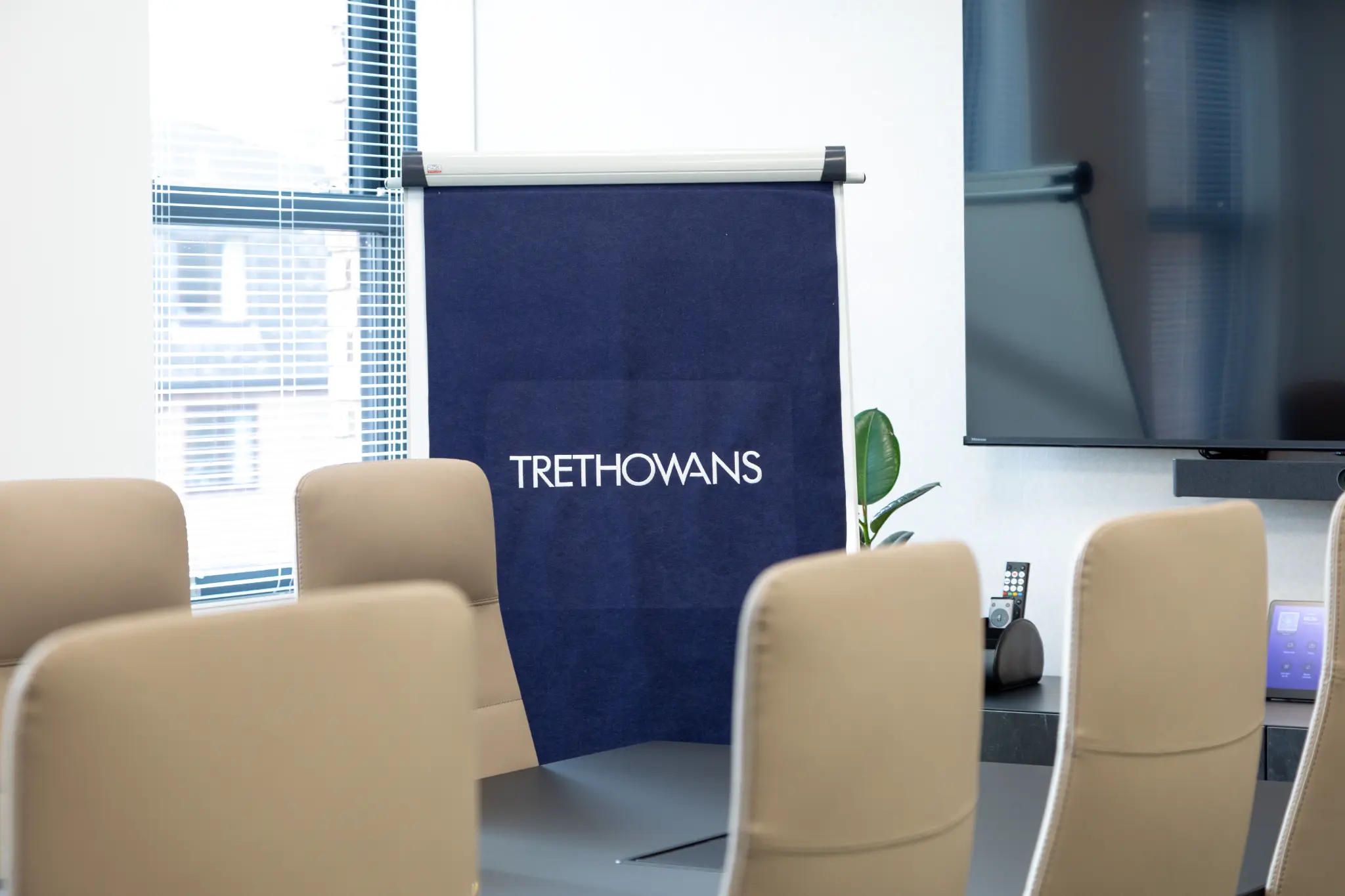 Boardroom with Trethowans branded banner and conference table