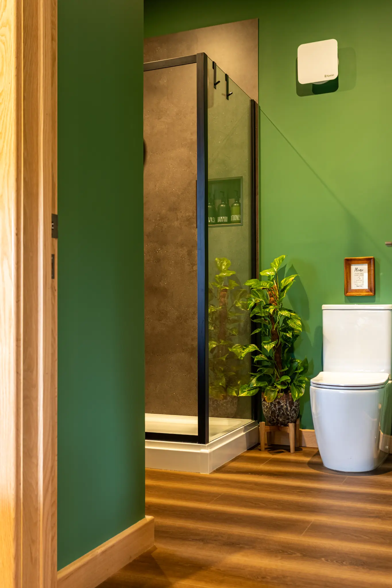 View through the doorway into the green en-suite at the Oak cabin