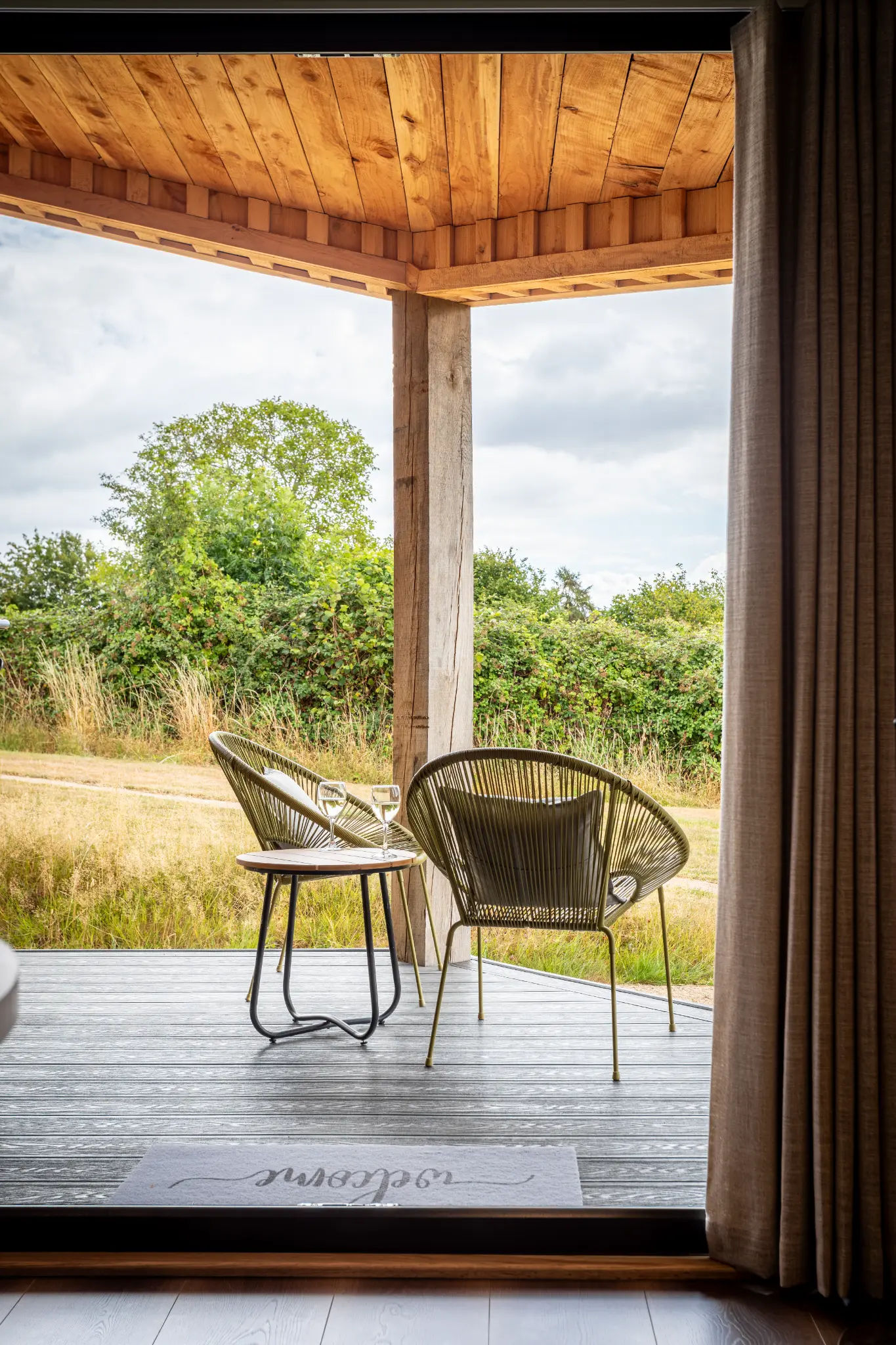 View out from the covered deck at Ochre Hill across open countryside