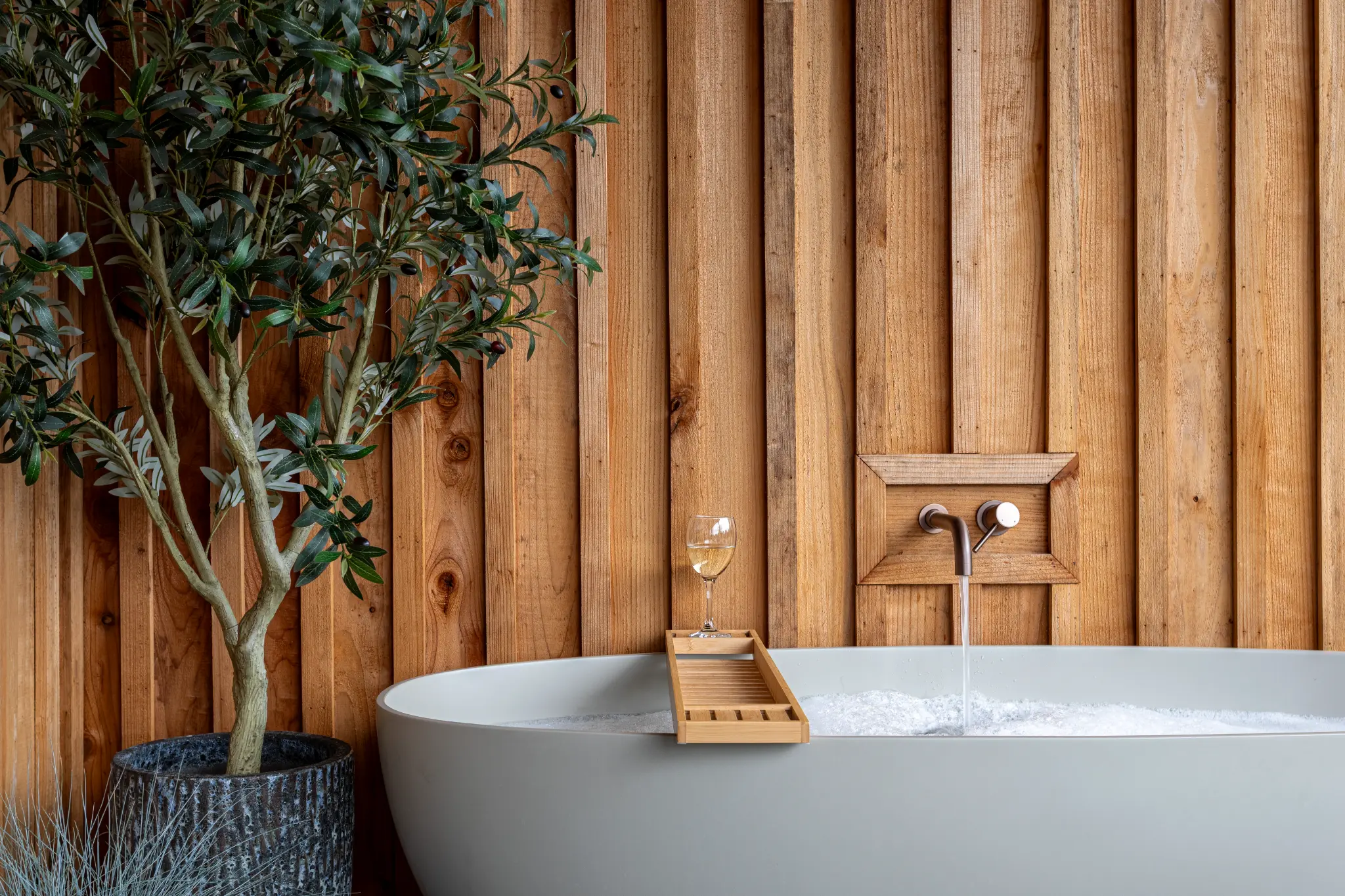 Water running into the outdoor stone bath at a luxury Gloucestershire lodge