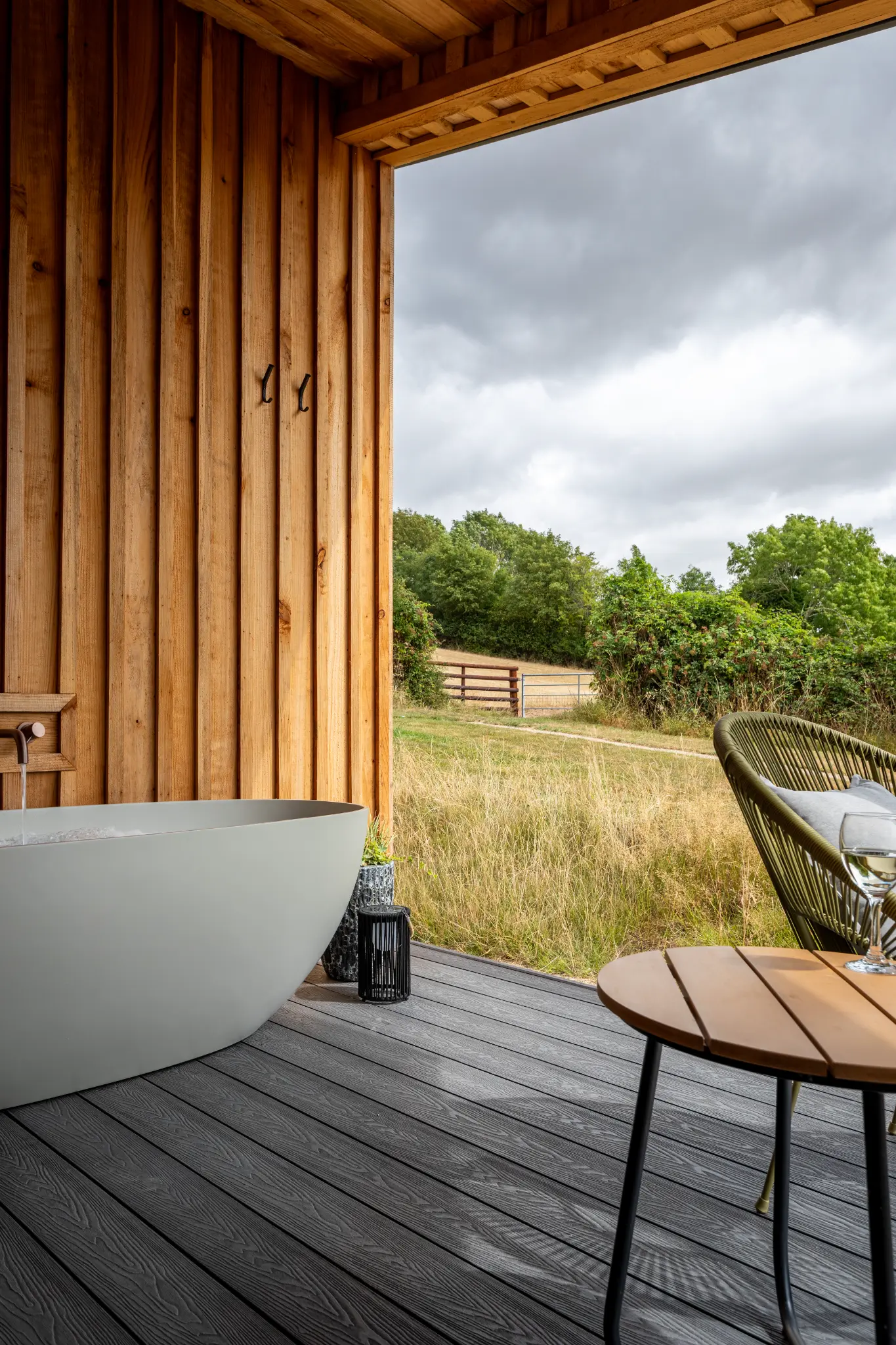 Deck corner at a luxury Gloucestershire lodge looking out over fields