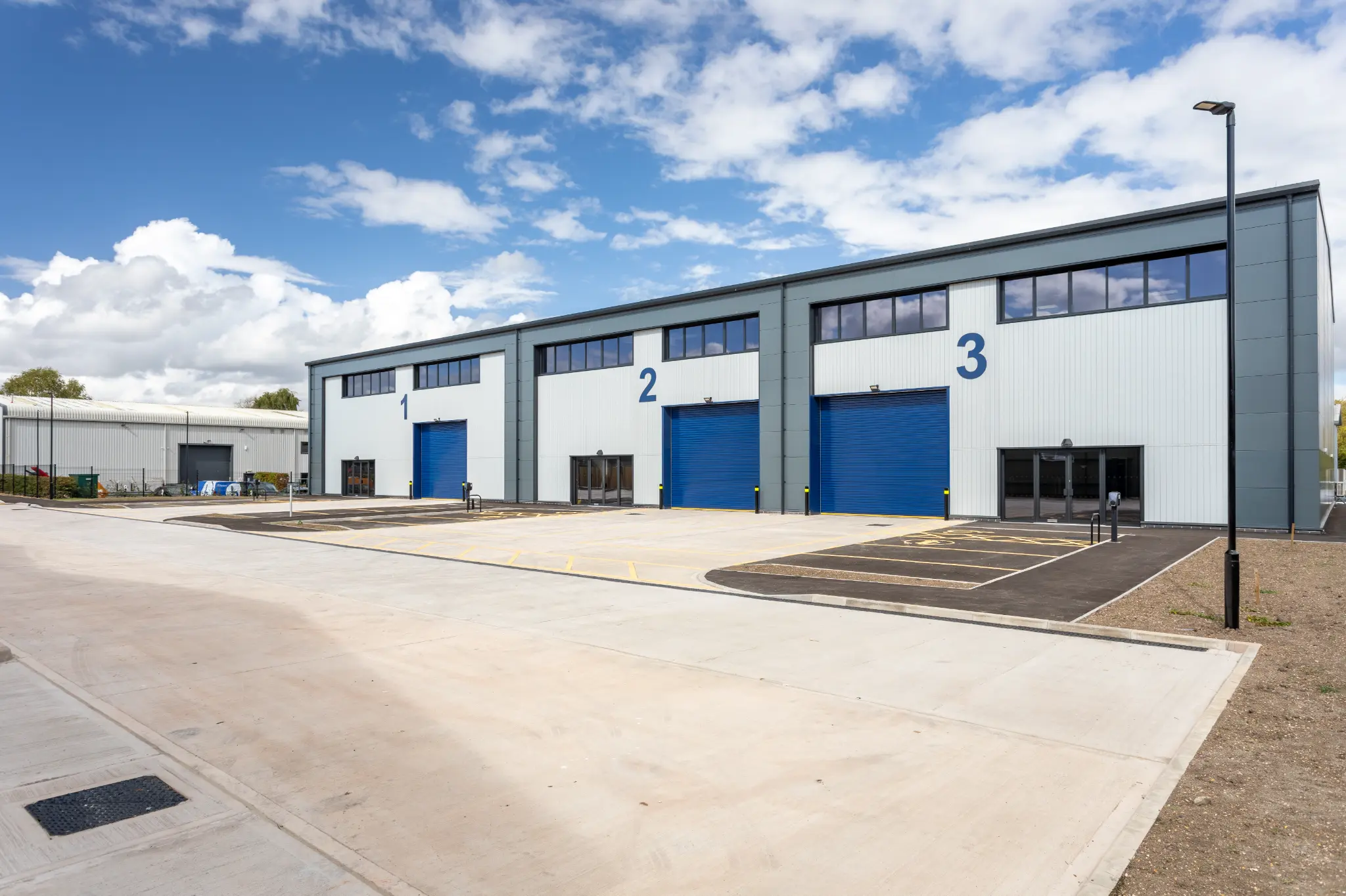Front elevation of Rotor Trade Park commercial units with blue loading doors