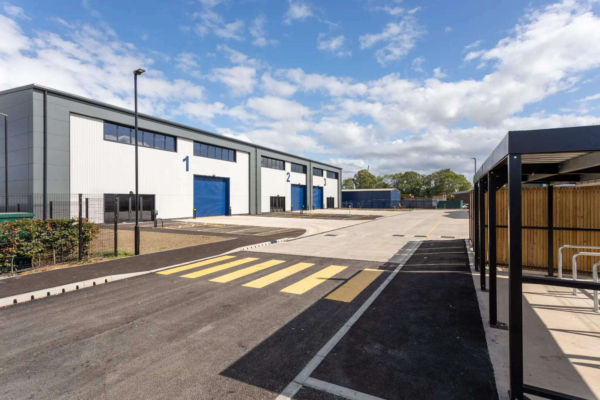 Arrival view of Rotor Trade Park with pedestrian markings and cycle shelter