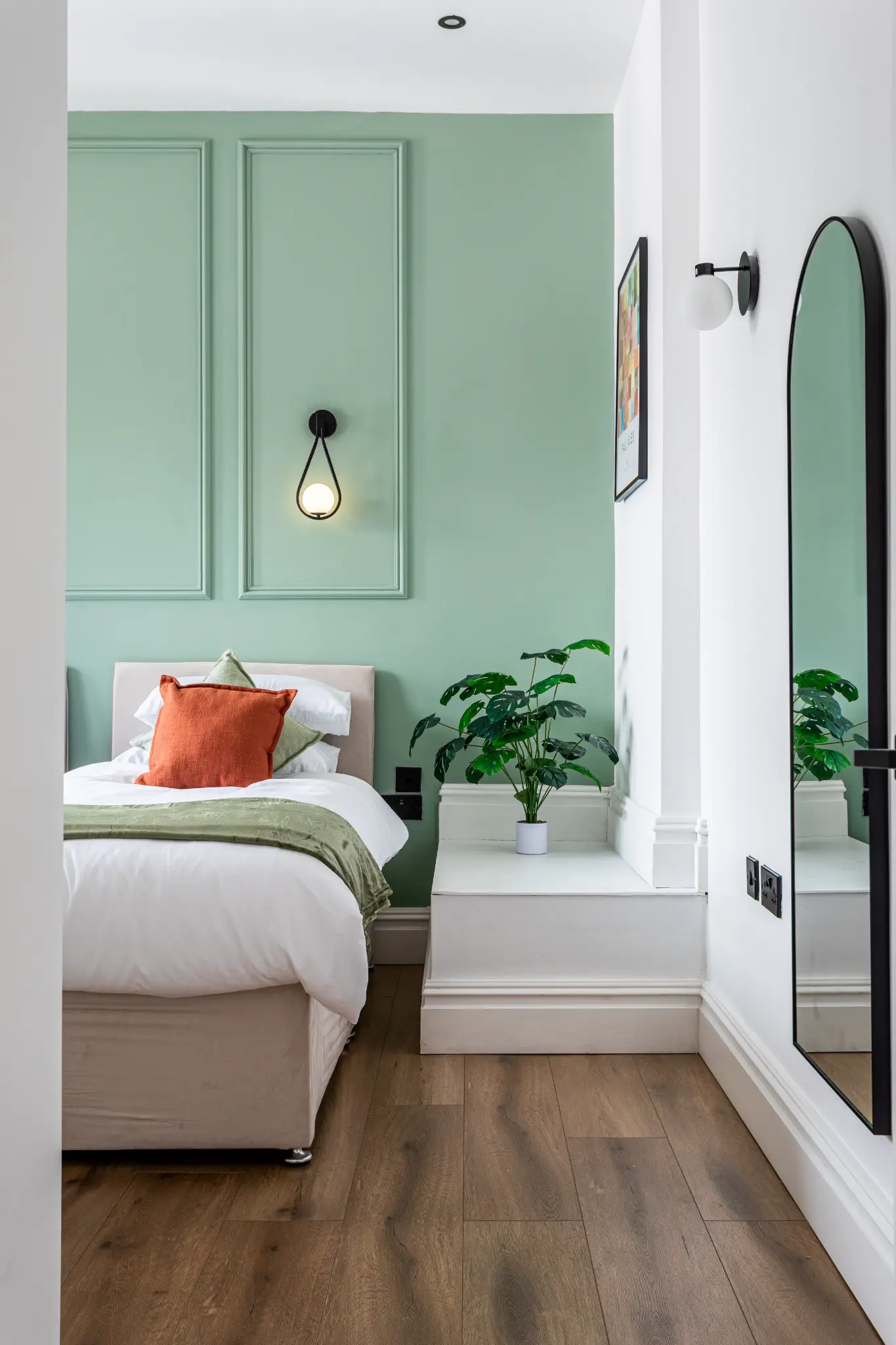 Mint green bedroom in a small city apartment